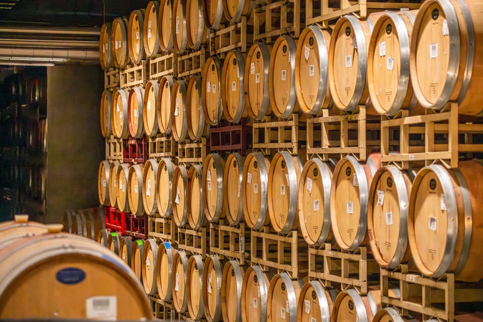 A stack of oak barrels in the wine cellar