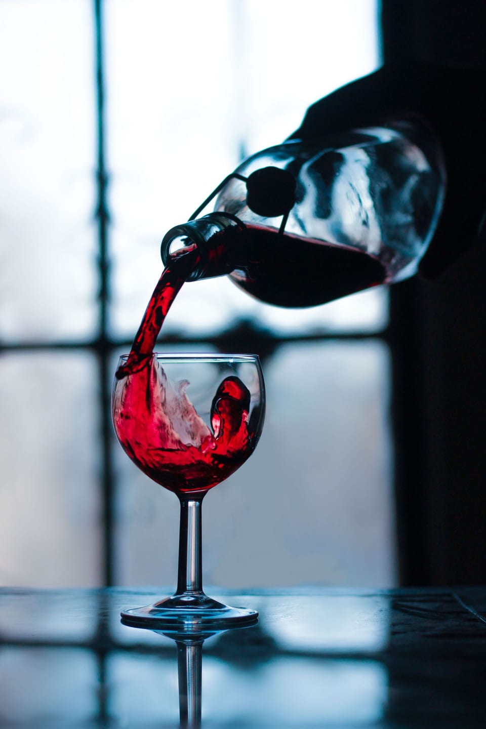 Wine being poured into a glass in the estate's tasting room